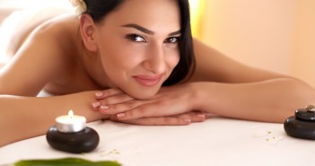 Treating Yourself To A Relaxing Weekend Spa Massage. Beautiful Brunette Gets Spa Treatment in Salon.